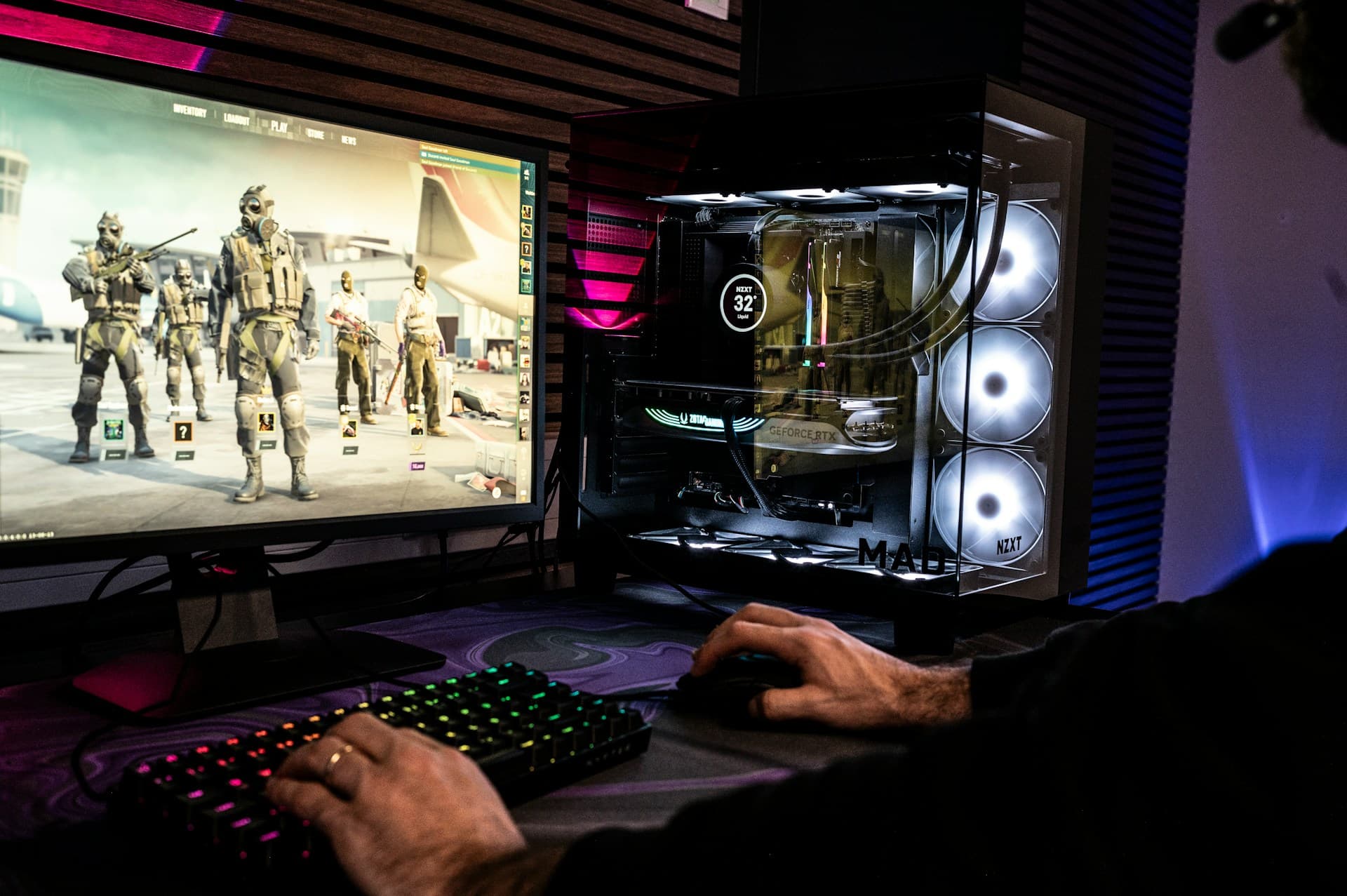 Person gaming on a PC with a GeForce RTX graphics card visible inside the case