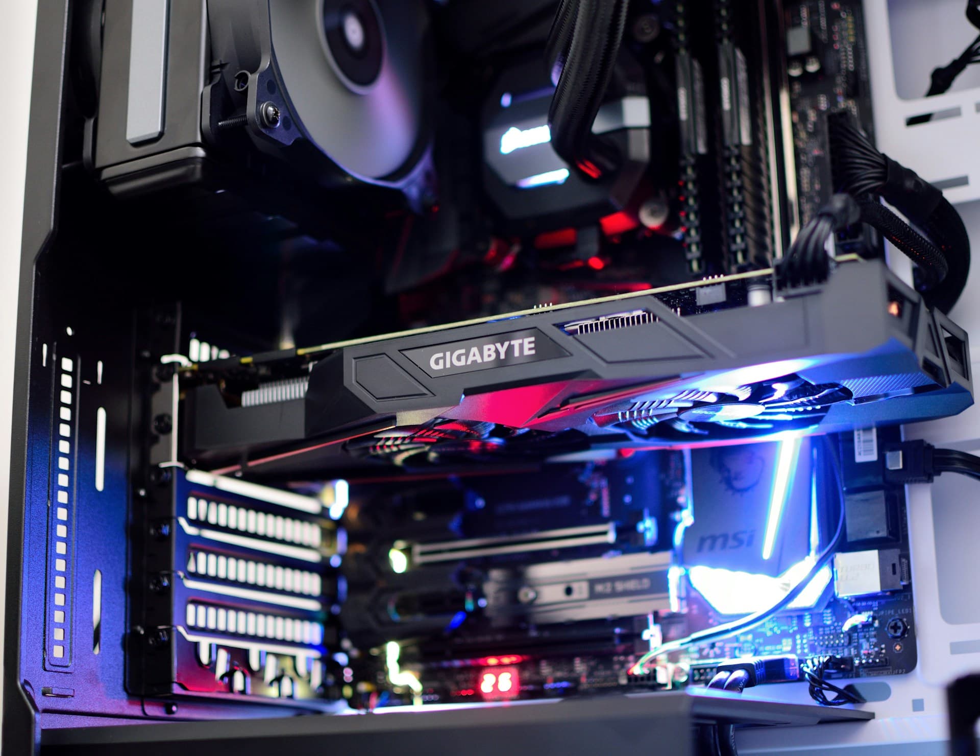 Gigabyte GPU installed in a PCIe x16 slot on an MSI motherboard inside a gaming PC case