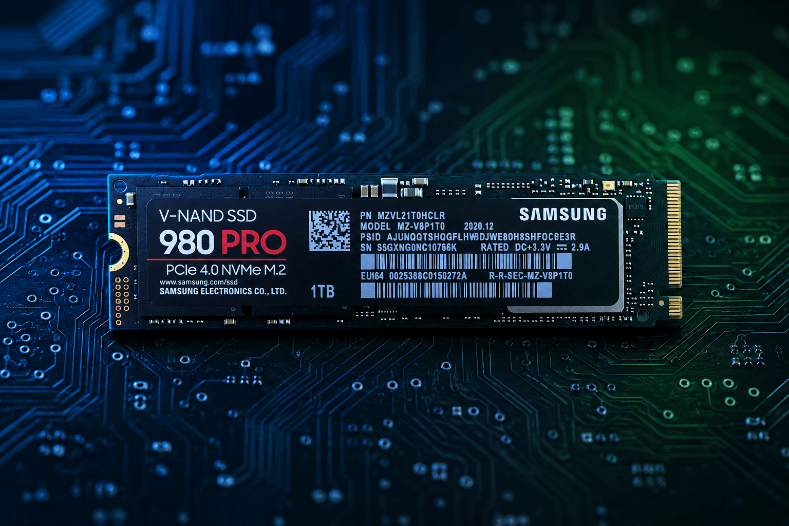 NVMe M.2 SSD lying flat on a circuit board background with blue and green ambient lighting