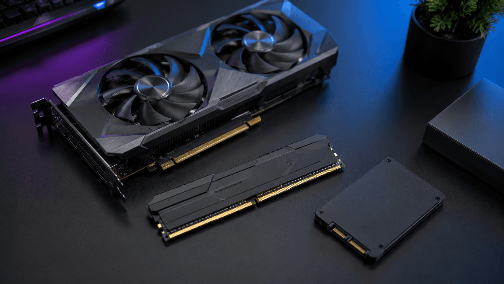 Graphics card, RAM stick, and SSD laid out side by side, representing the components to consider when deciding what to upgrade first on a PC